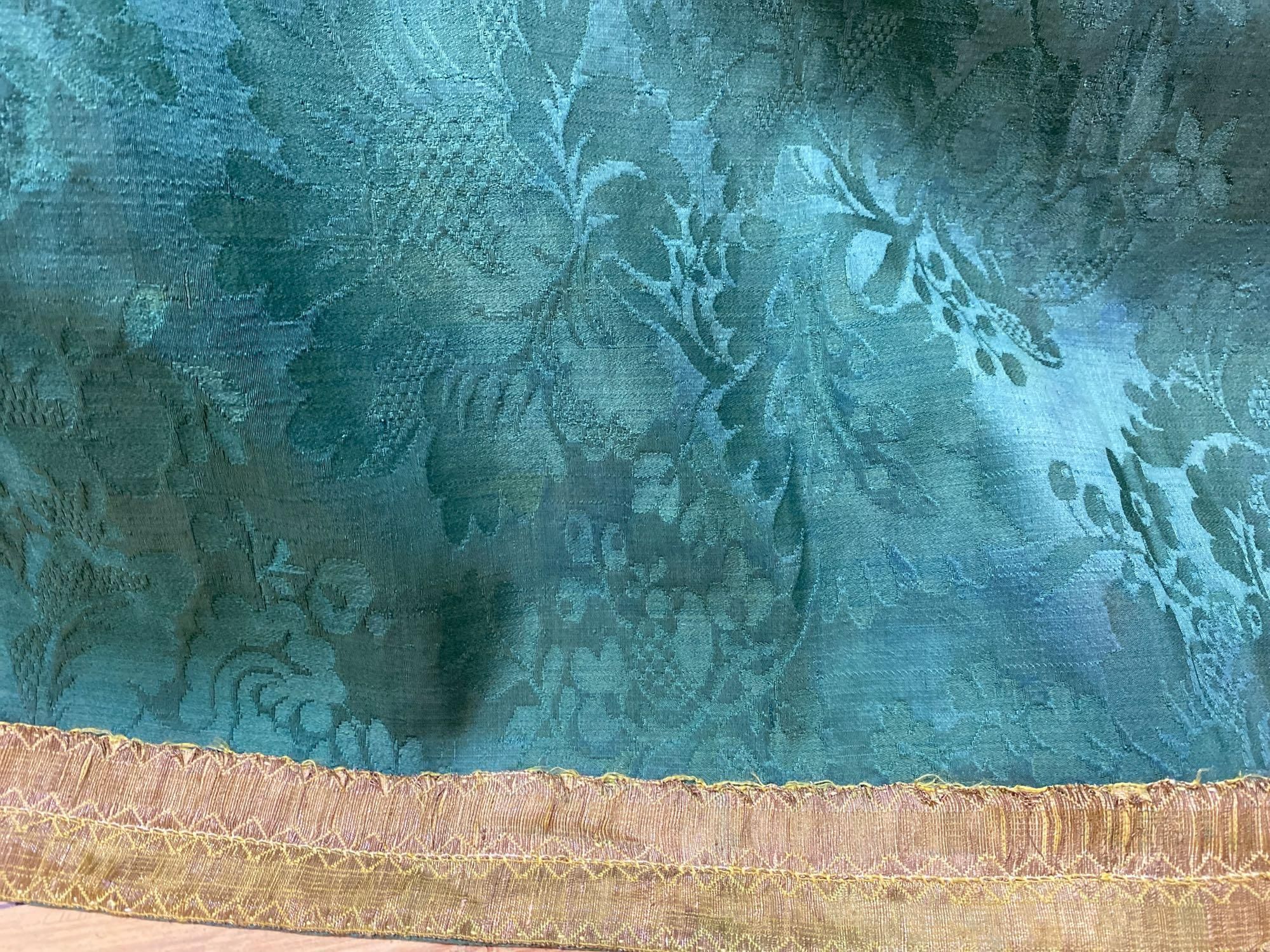 A mid-18th century joined coverlet of green silk damask,  74 x 94in (189 x 239cm)